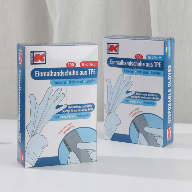 Guantes TPE suaves y respetuosos con el medio ambiente (patrón de puntos) de color blanquecino Guantes TPE suaves y respetuosos con el medio ambiente (patrón de puntos) de color blanquecino